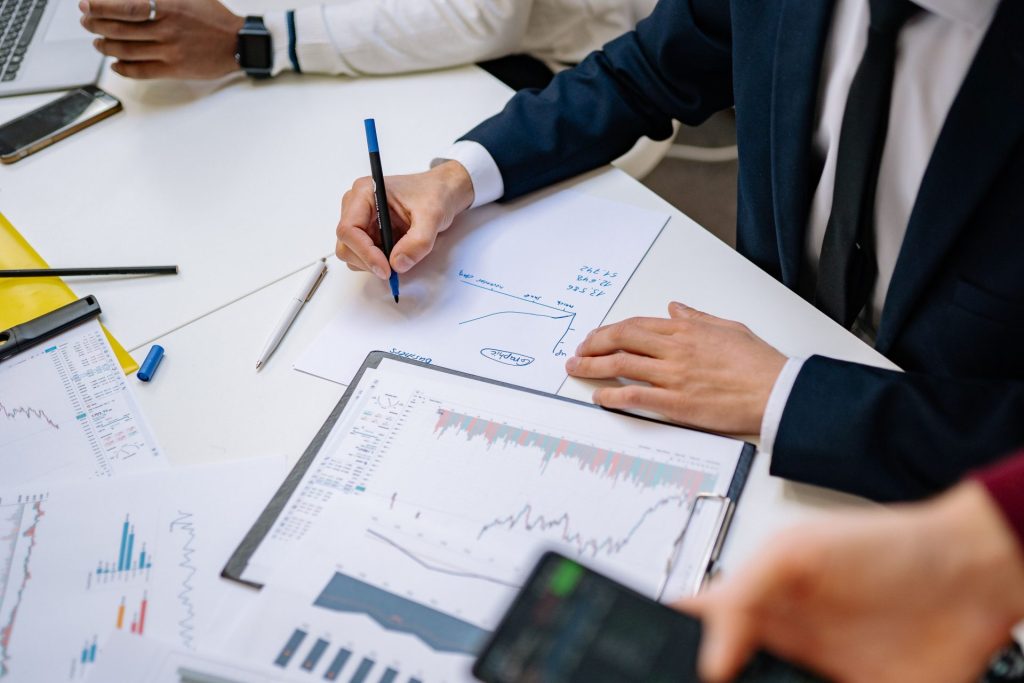 Fachleute, die Finanzcharts im Unternehmensumfeld analysieren.